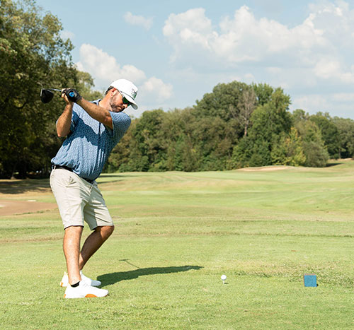 Man on green about to make a putt